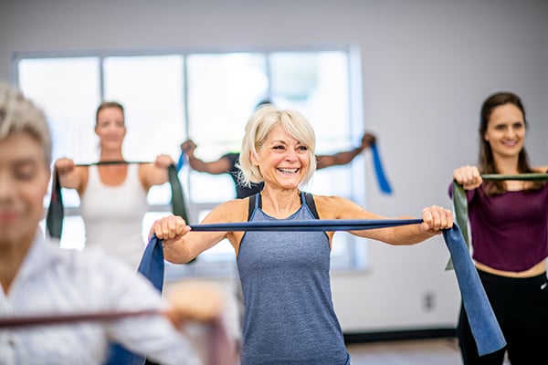 Woman in gym class with resistance band