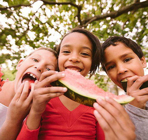 Kids eating watermelon