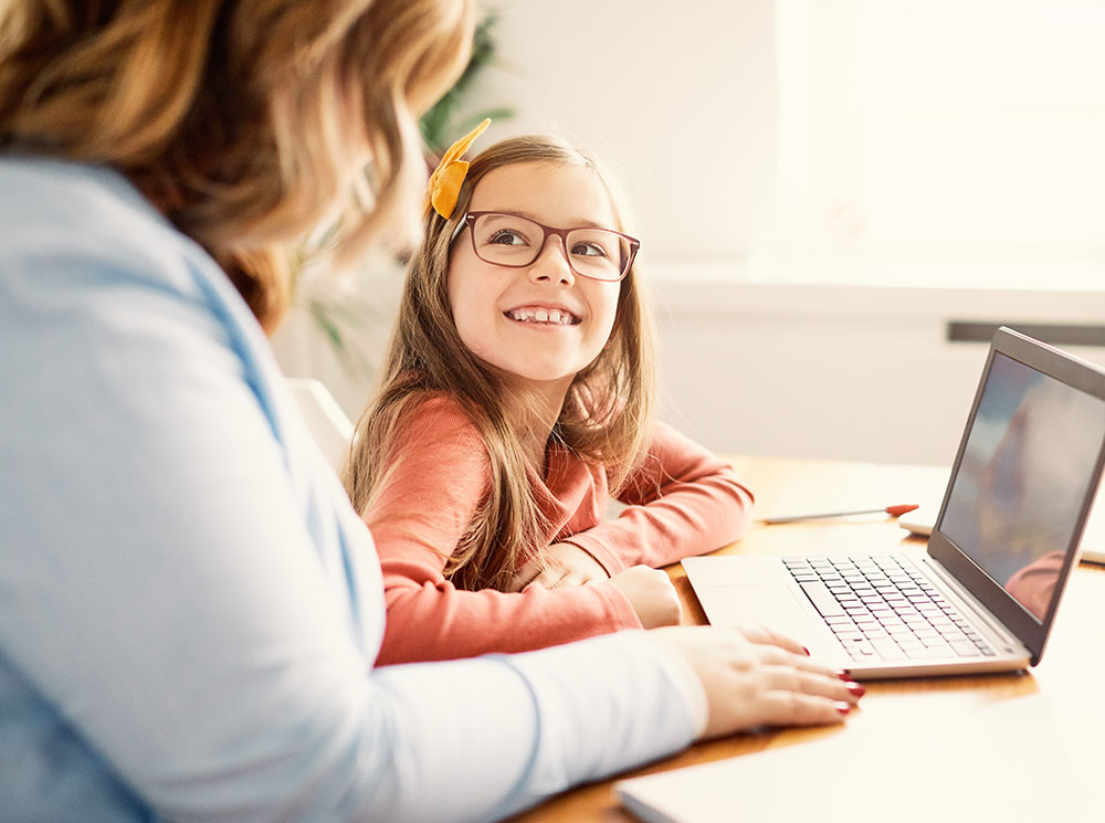 Mum and daughter at their laptop