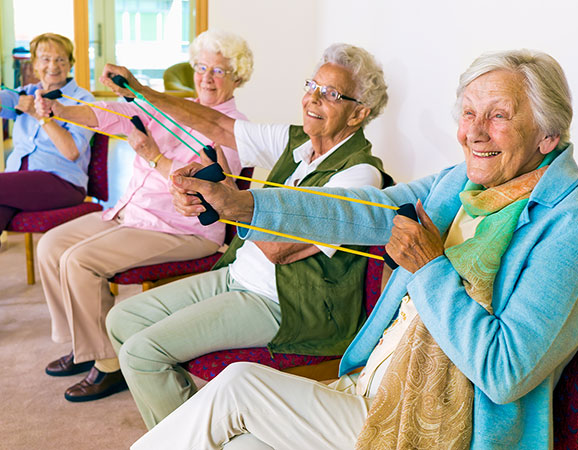 Women sitting down using resistance bands